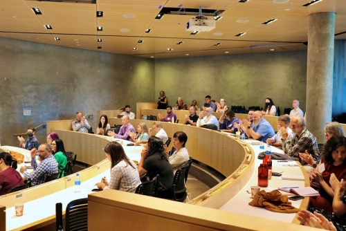 Attendees at the event gathering for research presentations