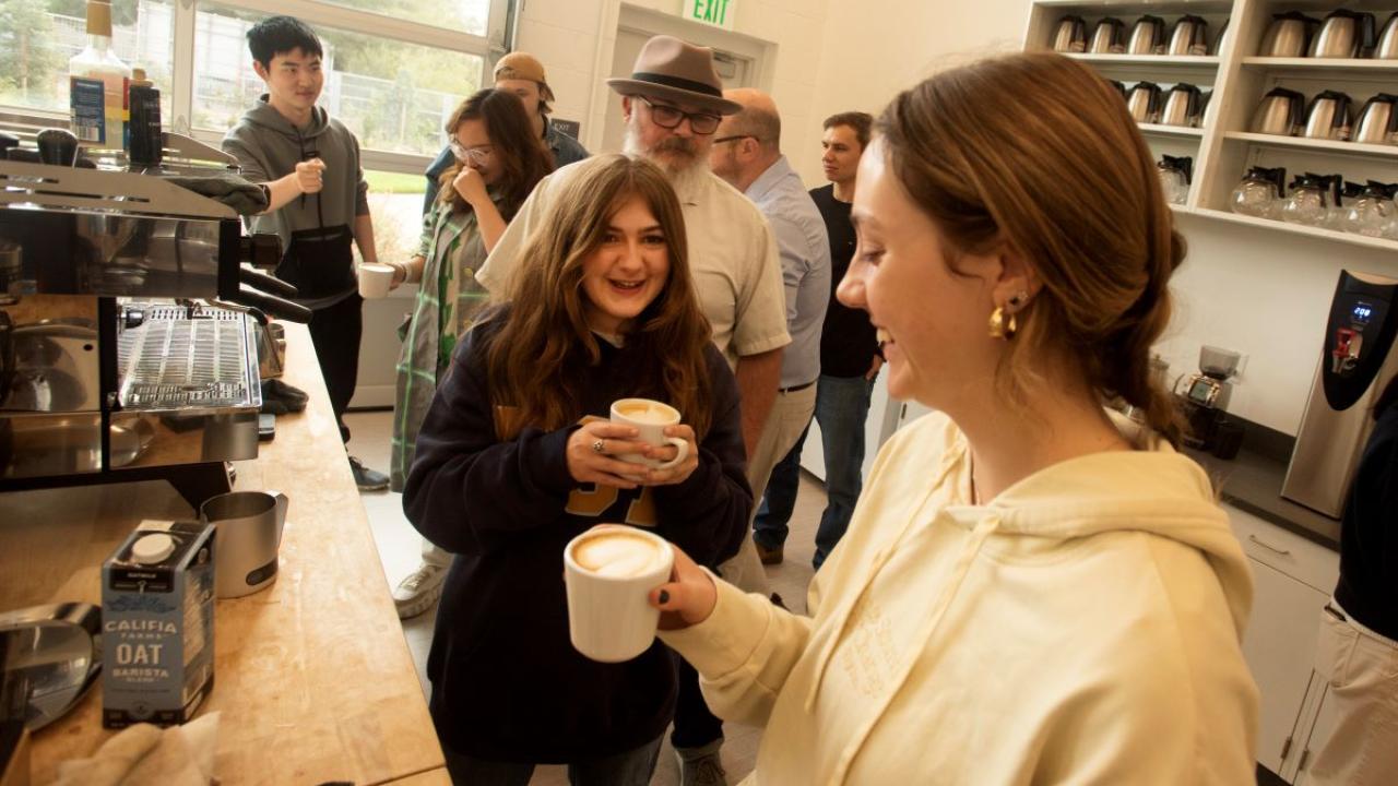 Phoebe Sothern, art studio and history major, and Daisy Moore, a communications major, talk over their newly made lattes during the coffee class at the Coffee Center 