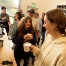 Phoebe Sothern, art studio and history major, and Daisy Moore, a communications major, talk over their newly made lattes during the coffee class at the Coffee Center 