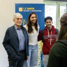 Jerry Baldwin stands with students in front of a College of Engineering banner