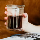 A person holding a cup of coffee